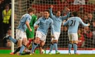 Manchester City's James Milner (L) celebrates with Samir Nasri (2nd L) after scoring at Old Trafford on April 8, 2013